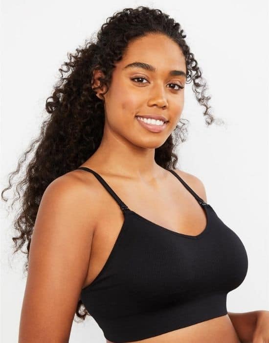 Photo of dark skinned woman smiling and wearing a nursing bra