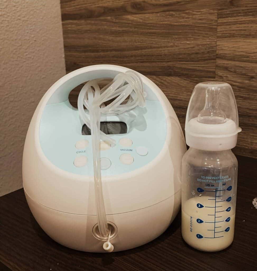 Spectra S1 Pump on nightstand next to a bottle of breast milk- Tips for Exclusively Pumping Moms