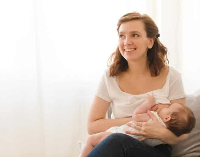 woman breastfeeding baby in the cradle hold