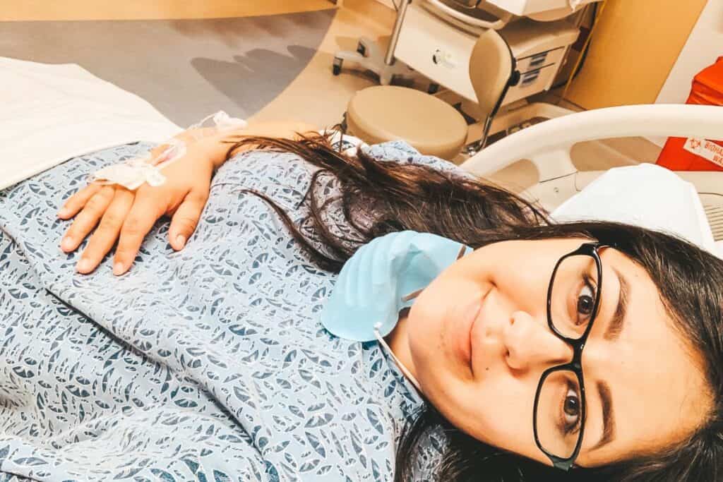 image of karissa of Mom After Baby in a hospital gown in a hospital bed right before childbirth 