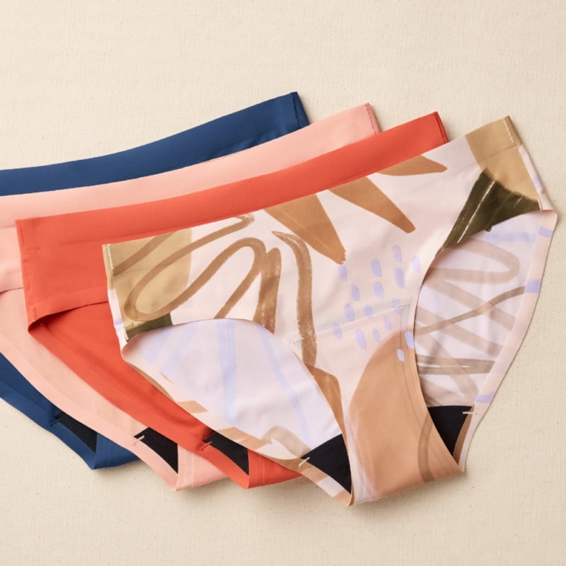 Knix leakproof underwear in a flatlay display against a beige background