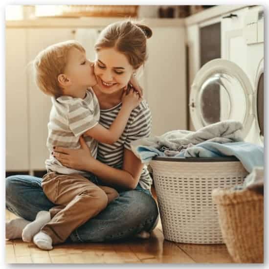 mom hugging son doing laundry