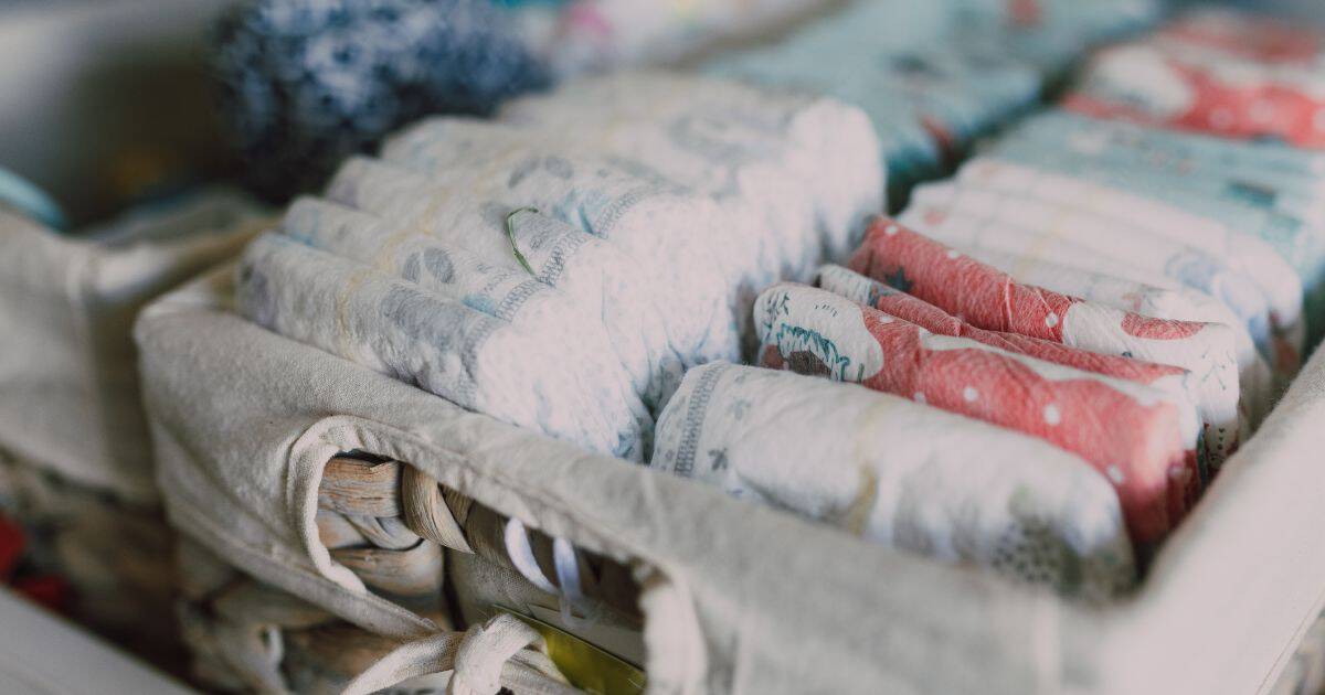 close up image of baby diapers inside of a woven basket