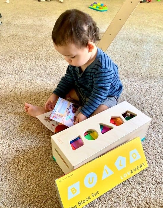 Young toddler playing with Lovevery's 'The Block Set' Montessori Toy