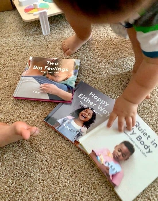 Lovevery toddler books about feelings and emotions laid out on the floor 