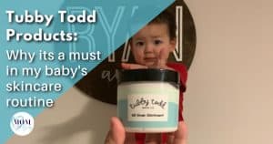 Photo shows young toddler standing and reaching out for Tubby Todd All Over Ointment Jar