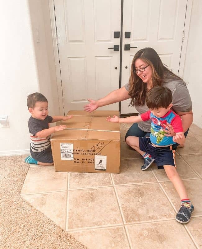 picture of myself and my 2 toddler boys opening our bentley trike box