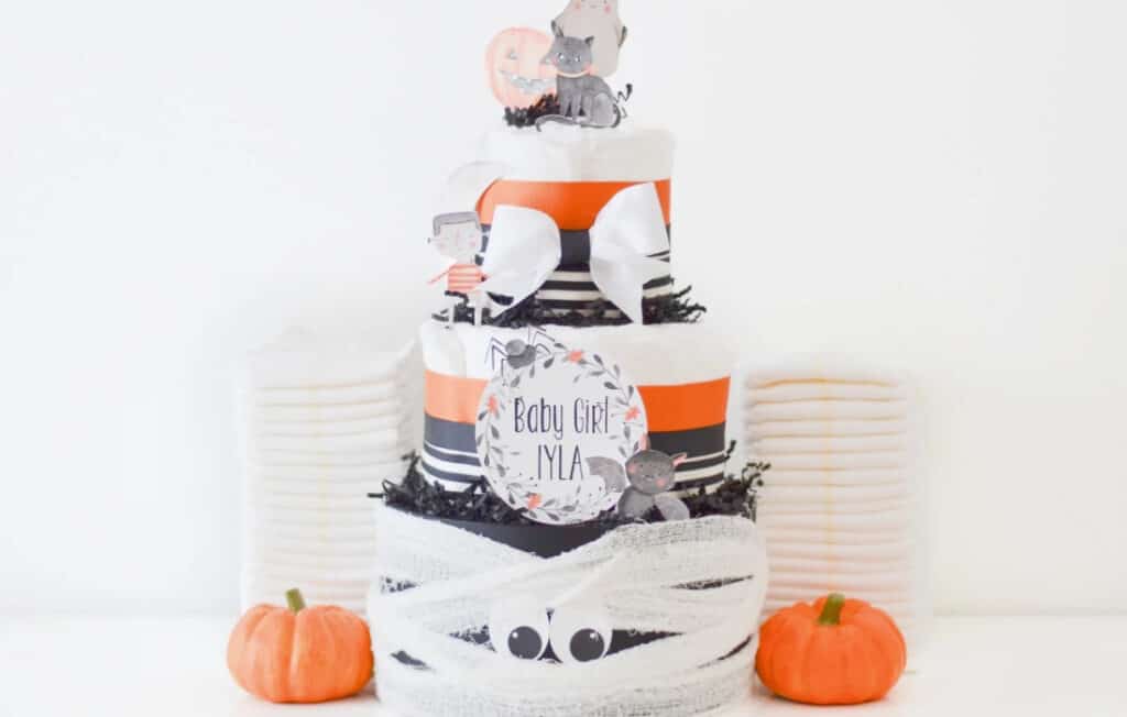 halloween diaper cake with pumpkins and a baby shower sign made from etsy