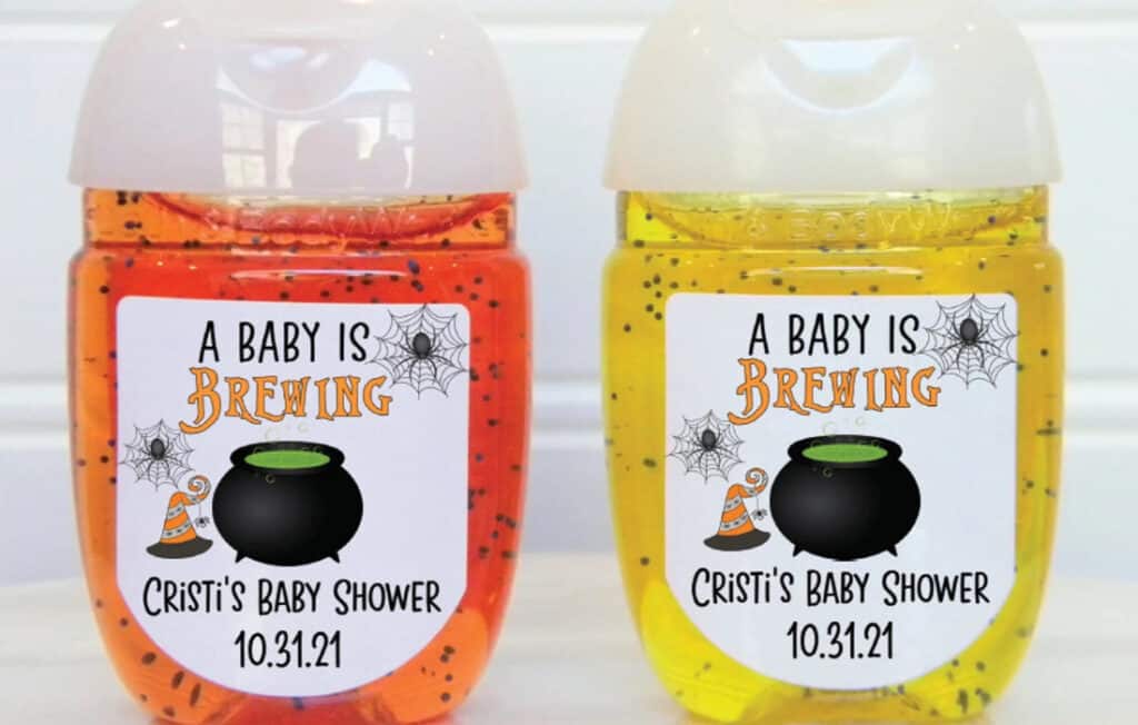 Image of orange and yellow hand sanitizer party favor with halloween theme label on them form etsy