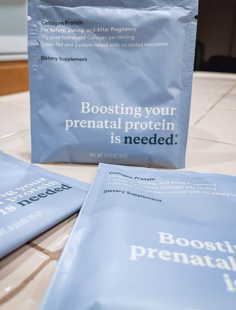 Close up image of Needed Prenatal Collagen protein travel packs. The packs are light blue in color and are on a tan countertop