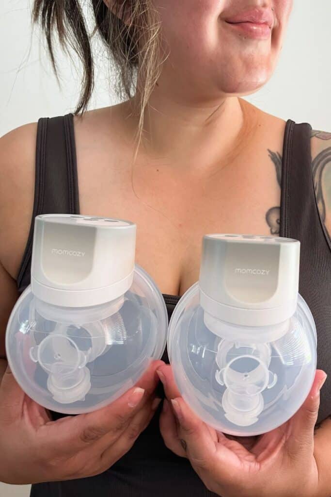 Image of Karissa of Mom After Baby wearing a charcoal colored crop top and holding a pair of the Momcozy S12 Breast Pumps