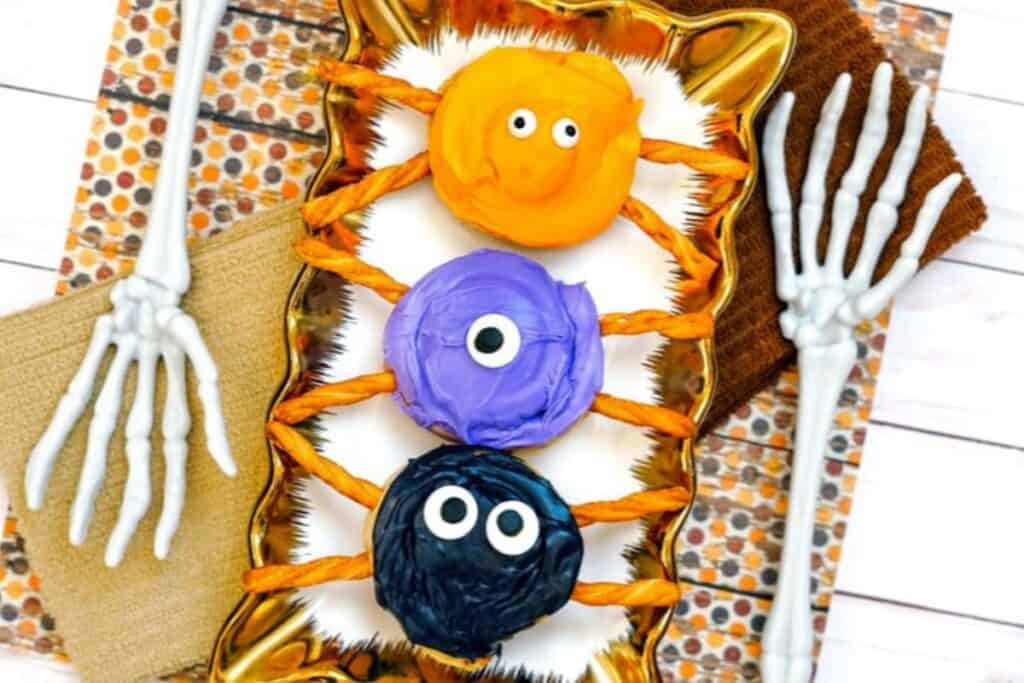 This image shows 3 cinnamon rolls decorated in a halloween themed spider decoration