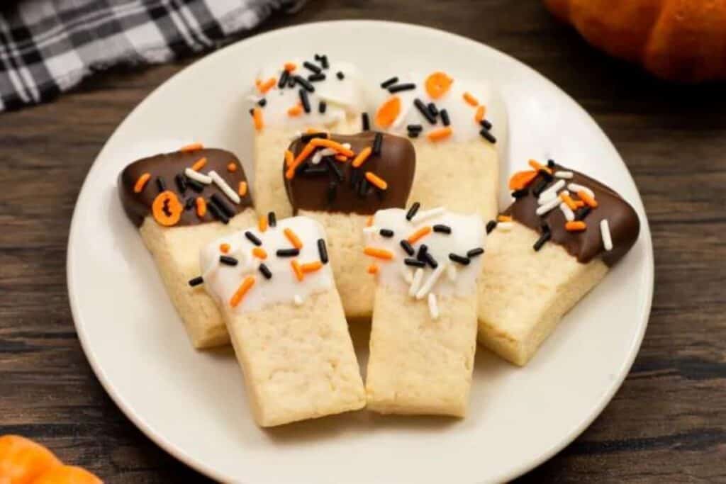 This image shows a display of shortbread cookies decorated with frosting and sprinkles for halloween