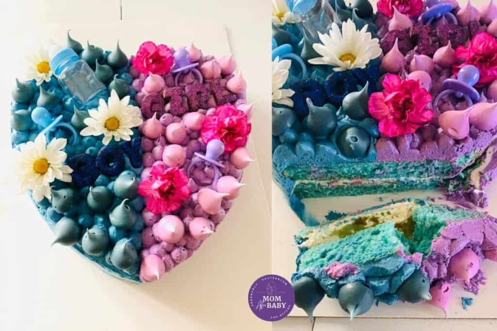 This image shows Karissa of Mom After Baby's heart shaped gender reveal cake with the left side blue and the right side of the cake pink and purple. On the far right, you can see the cake was cut to reveal the gender of baby was a boy!  