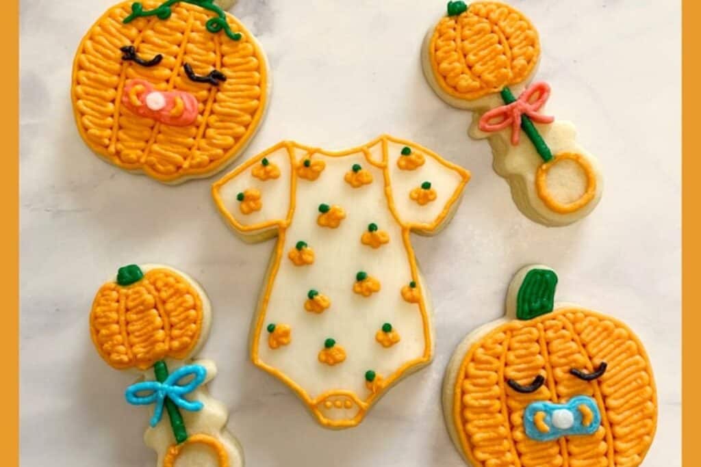 This image is from Buttercream Parties - it shows pumpkin cookies decorated in a baby/pregnancy/gender reveal style.