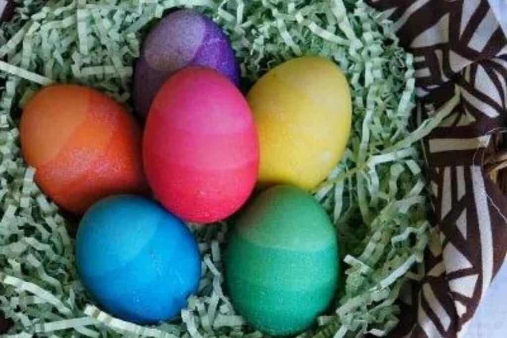 Image of easter eggs in a faux grass basket (ombre colored) made by Honey & Lime