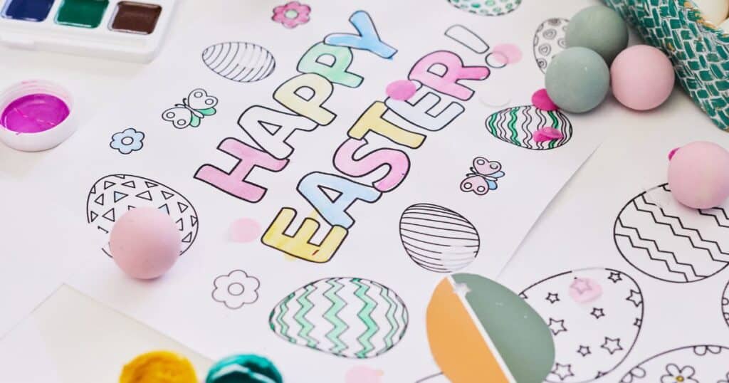easter egg crafts for kids — image shows a coloring page that says happy easter with easter decor scattered around