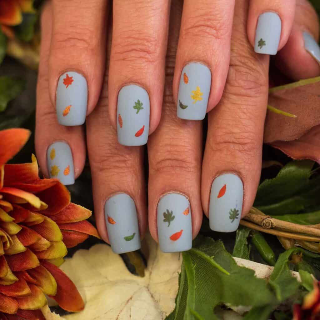 pastel blue nails with leaves design on them