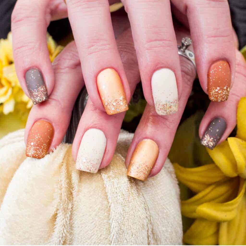 orange and white with glitter fall nails