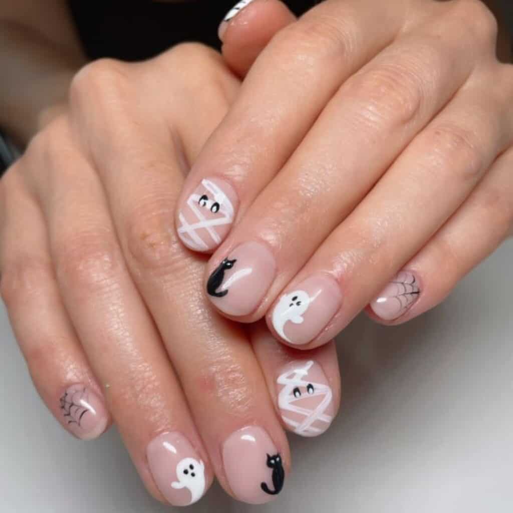 adorable halloween nails (ghosts, mummy, and cat) design by @polishbychloe on Instagram