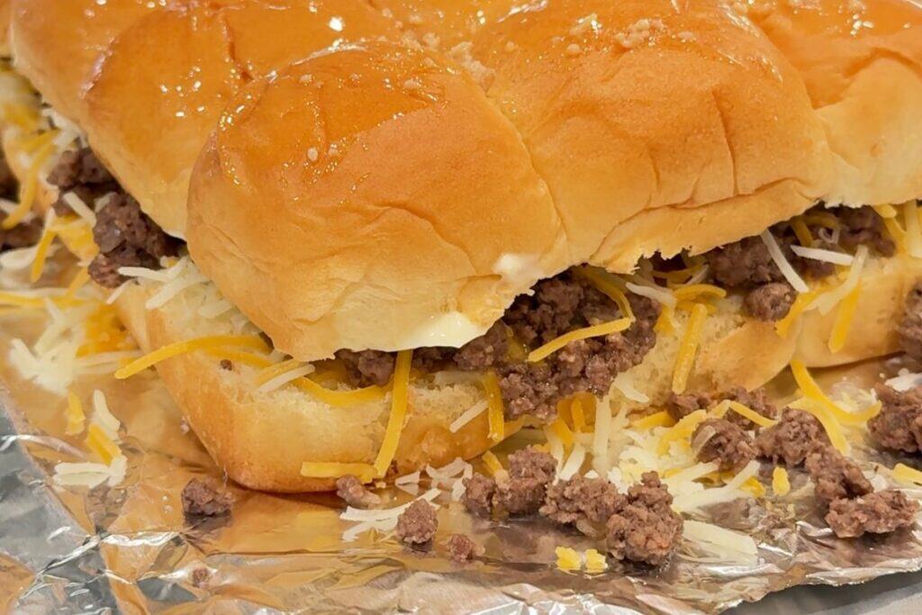 Homemade finger food cheeseburger sliders on a piece of foil