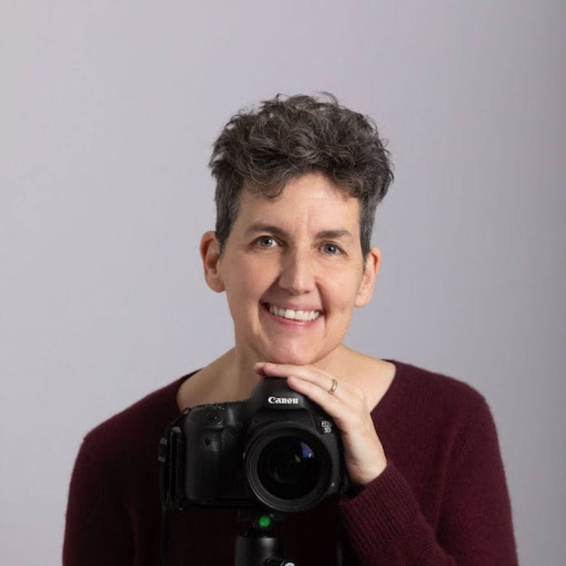 professional headshot image of Katie Katsenis posing with her camera