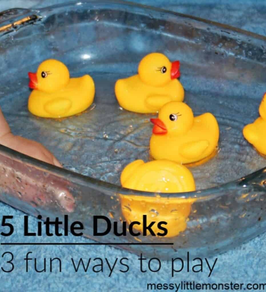Close up image of a shallow glass container full of water and floating yellow ducks 