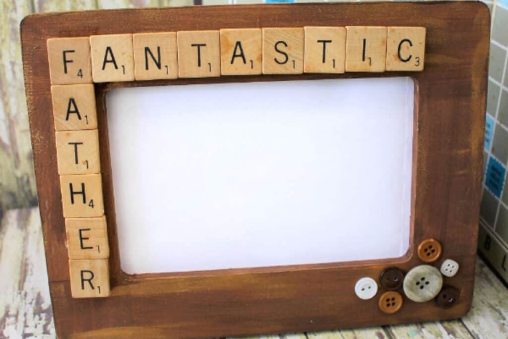 close up image of a wooden father's day frame decorated with scrabble tiles