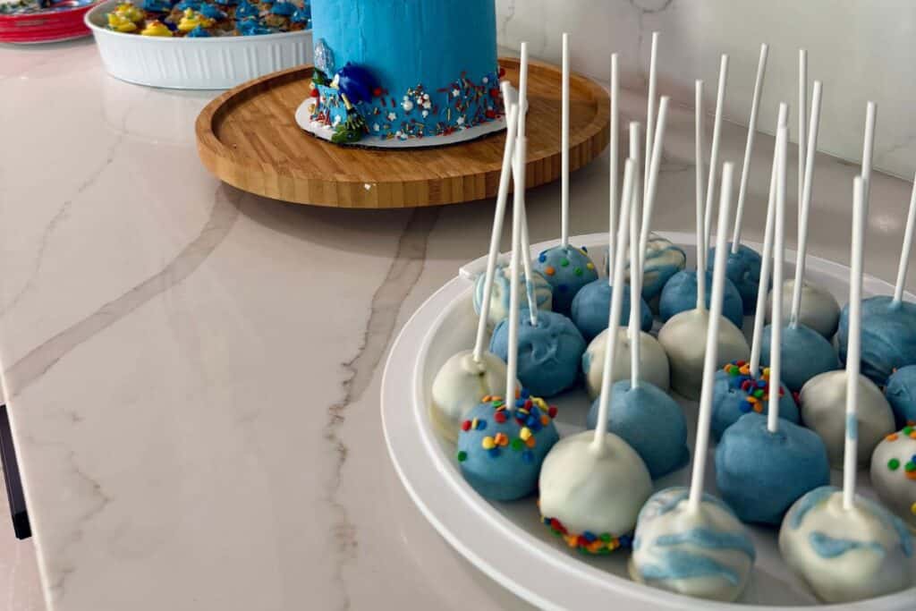 Sonic birthday party dessert table with blue and white frosted cake pops in front