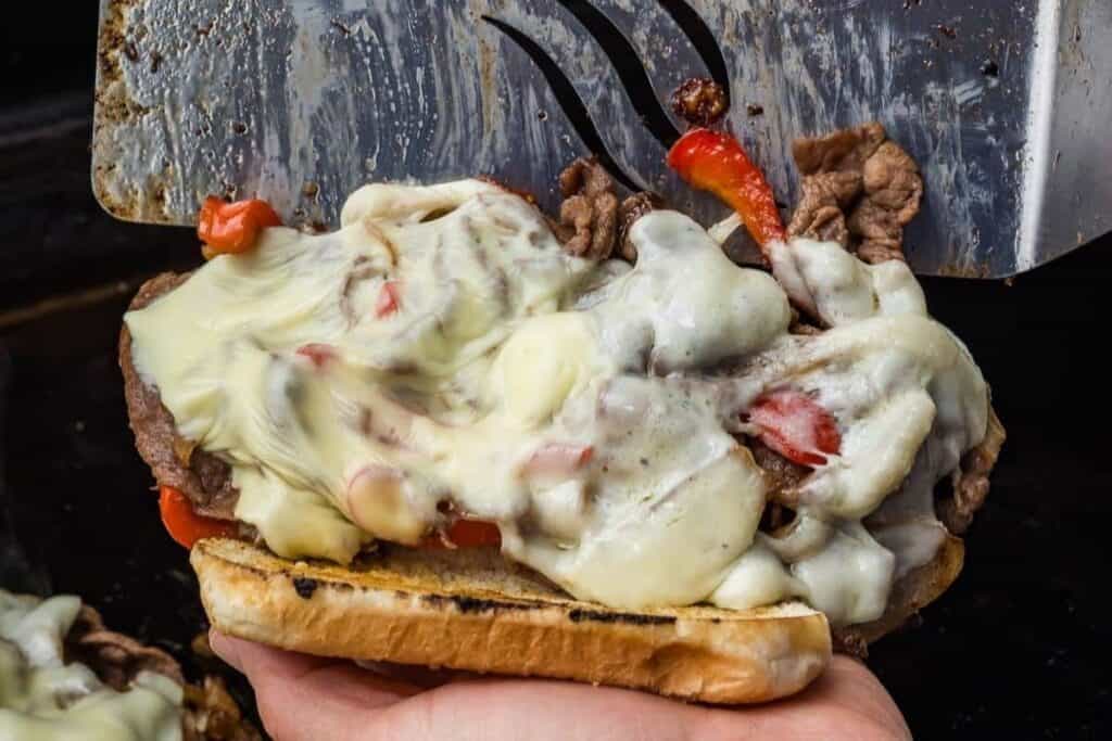 close up image of melted cheese on a Philly Cheesesteak Sandwich