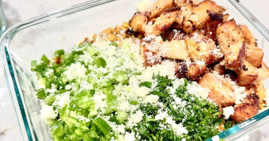 close up image of a street corn chicken salad in a glass pyrex container (its the cover image for the Easy Summer Dinners article)