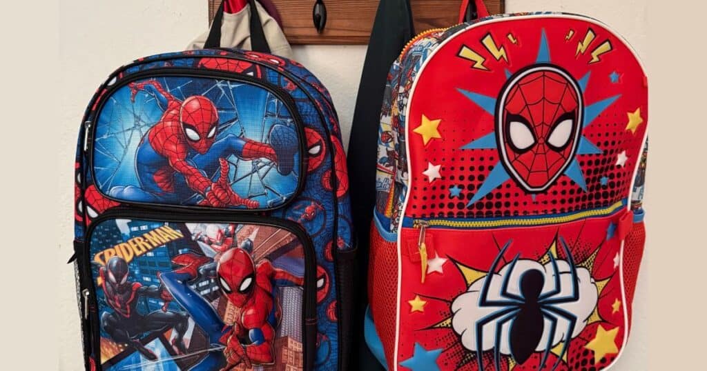 close up image of 2 kids spiderman backpacks hanging on a coat rack