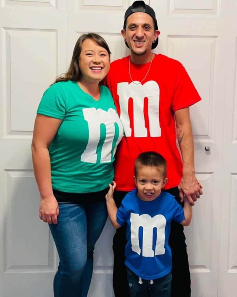 Family of 3 dressed in M&M shirts for halloween