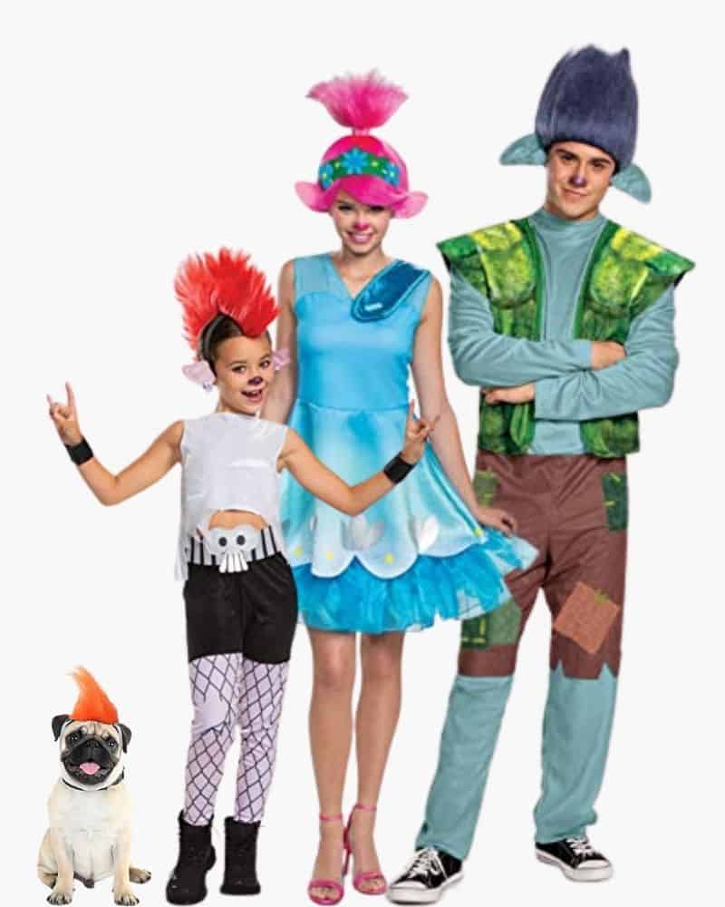3 people dressed in Trolls halloween costumes and a dog with a troll wig on.