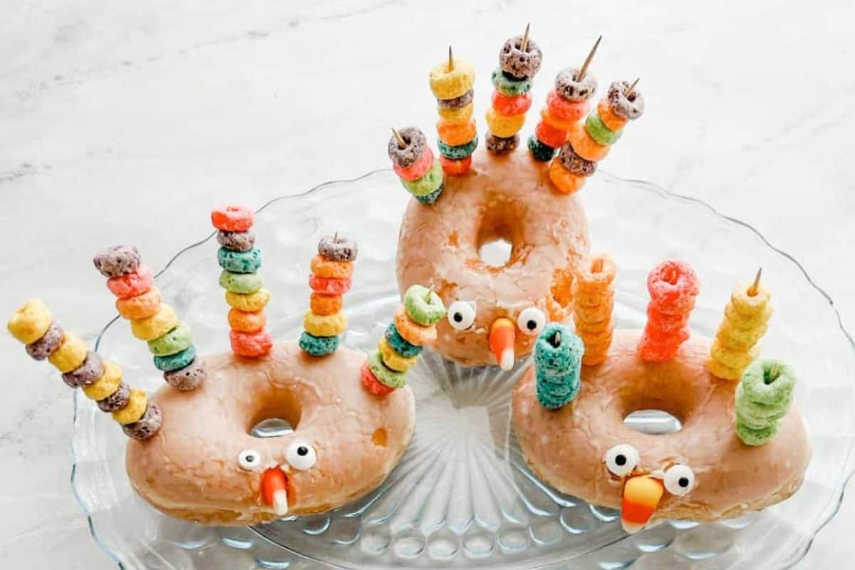 donuts decorated to look like turkeys with cereal, candy corn, and more