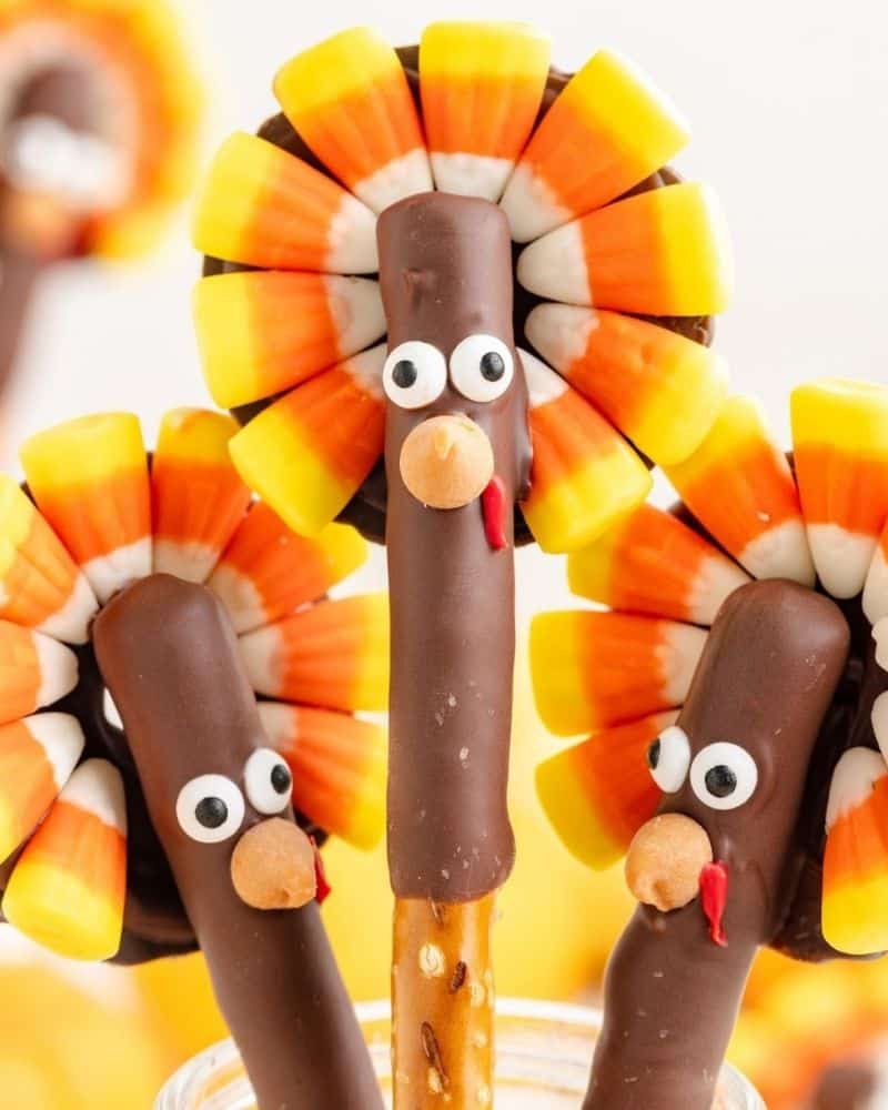 image of pretzel rods decorated to look like turkeys using candy eyes, candy corn, and other edible items