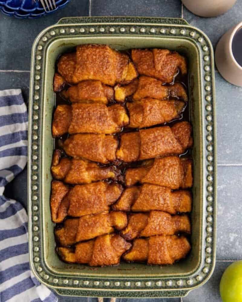 delicious crescent roll wrapped apple dumplings lined up in a baking dish