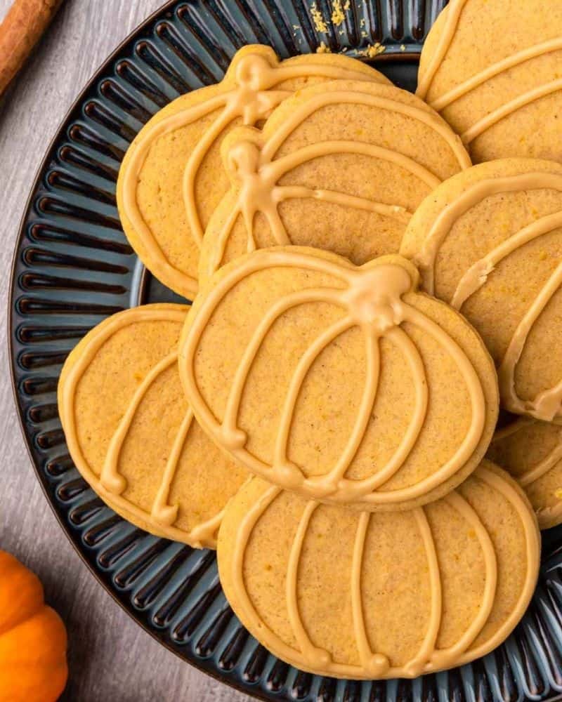 pumpkin shaped sugar cookies outlined with maple glaze