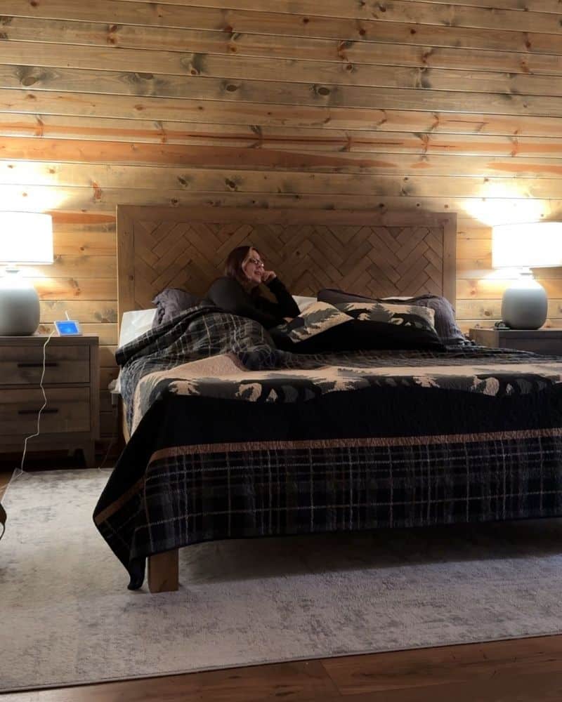Master bedroom of a Luxury Big Bear Cabin with me sitting in bed