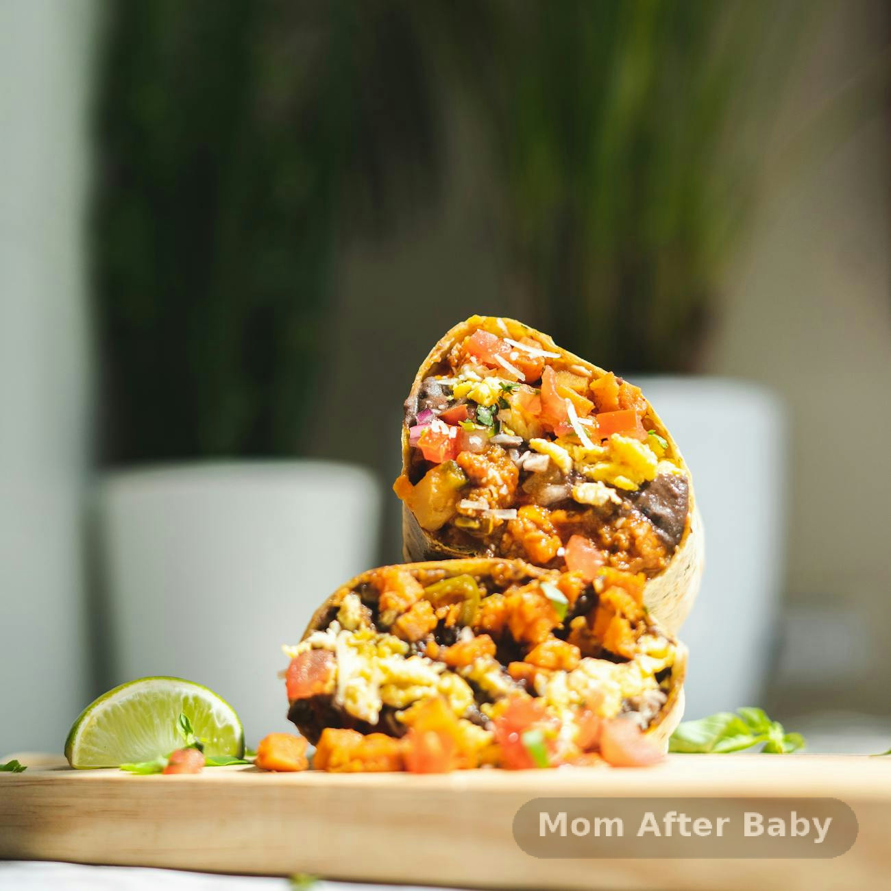Breakfast burrito ingredients including eggs, tortillas, peppers, and cheese arranged on a wooden board alongside a bowl of homemade oat energy bites