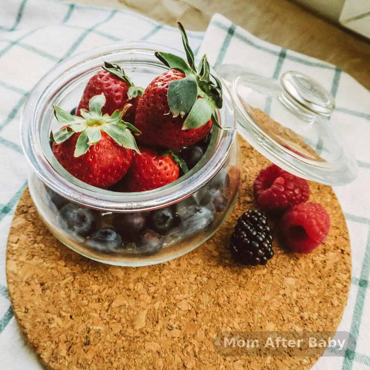 Mason jars filled with overnight oats topped with fresh berries and honey