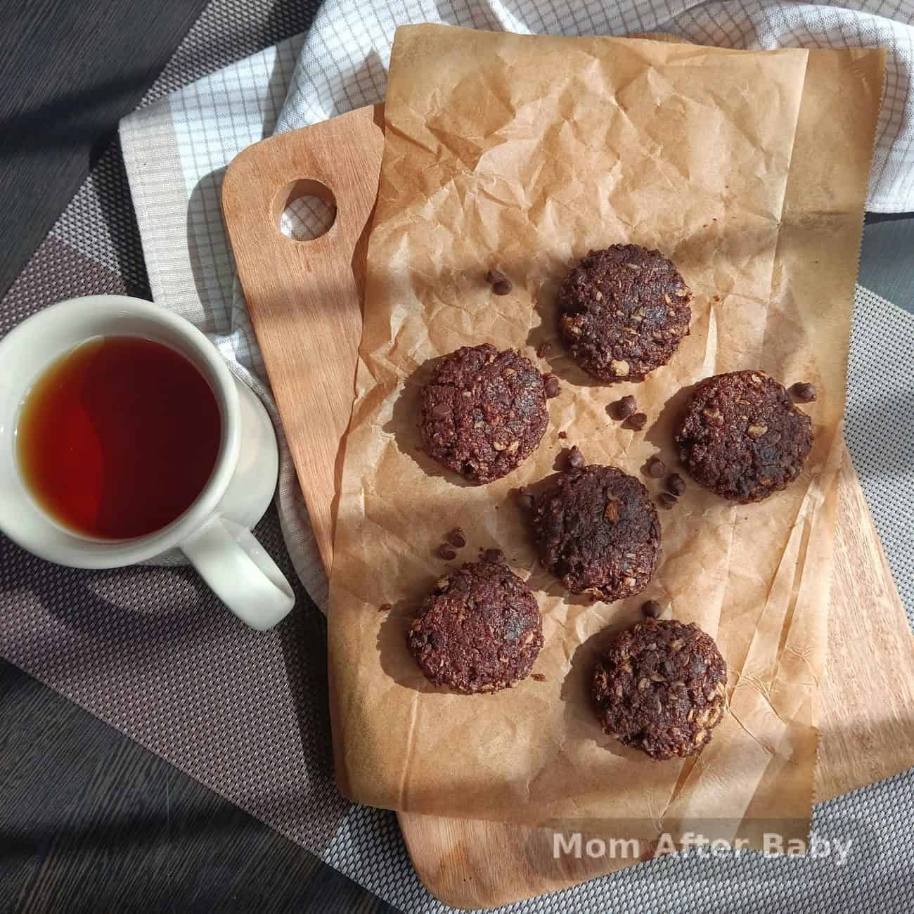 Homemade energy bites made with oats, honey, and chocolate chips on parchment paper