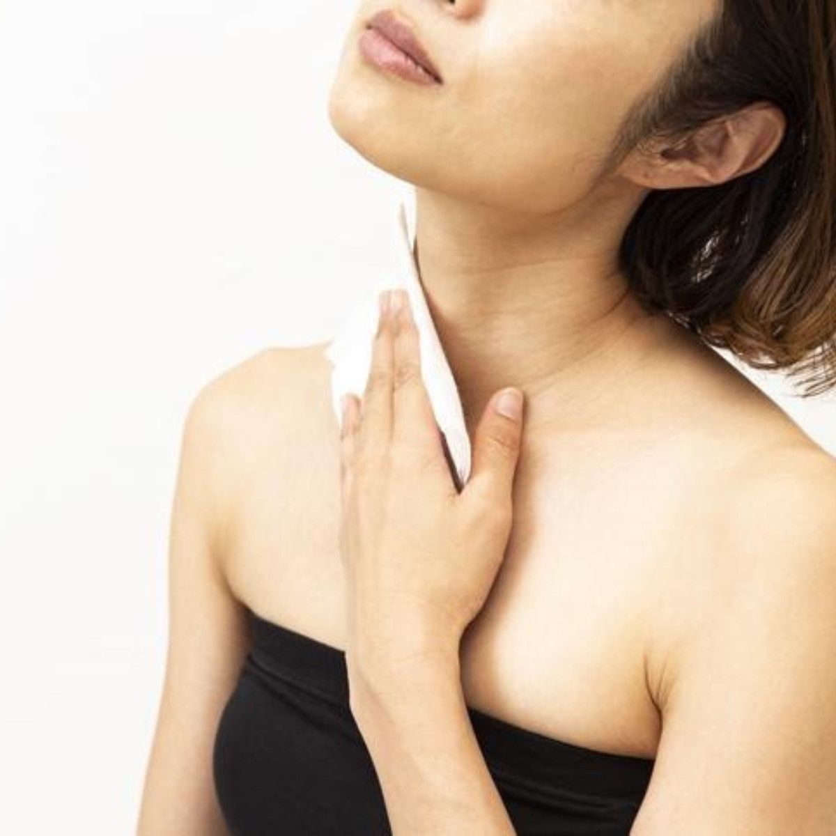 Women washing her neck with a towel while being postpartum.
