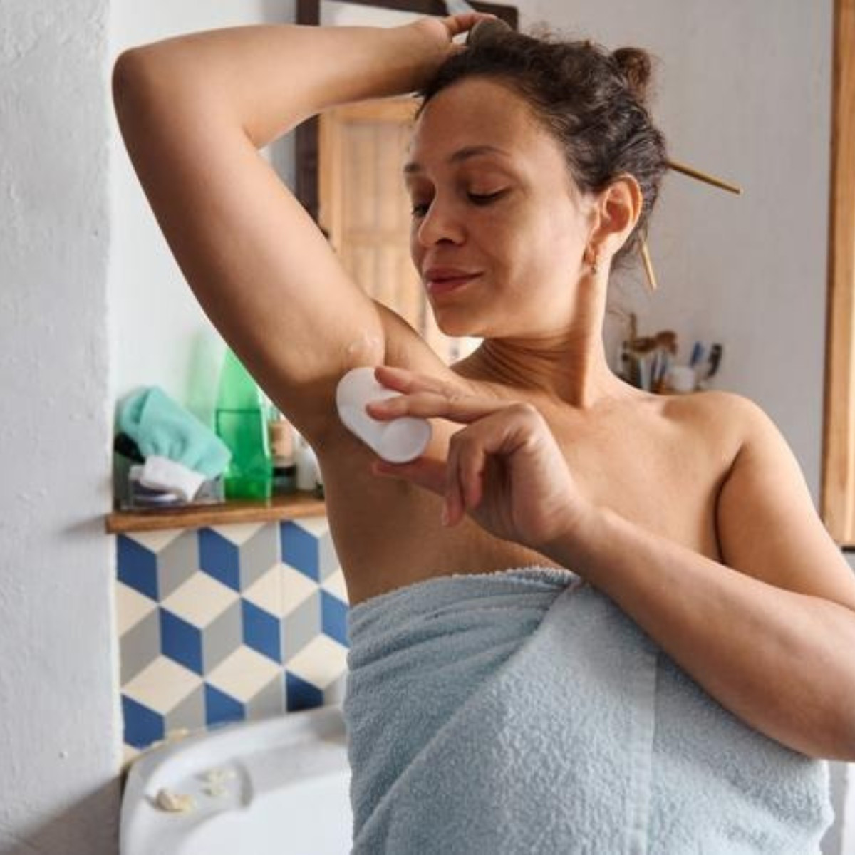 Mom using deodorant while being postpartum.