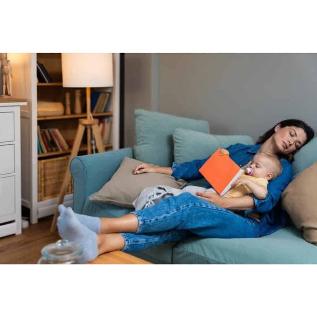 Mom sleep deprived postpartum while holding her baby.