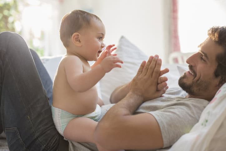 Husband playing with his baby