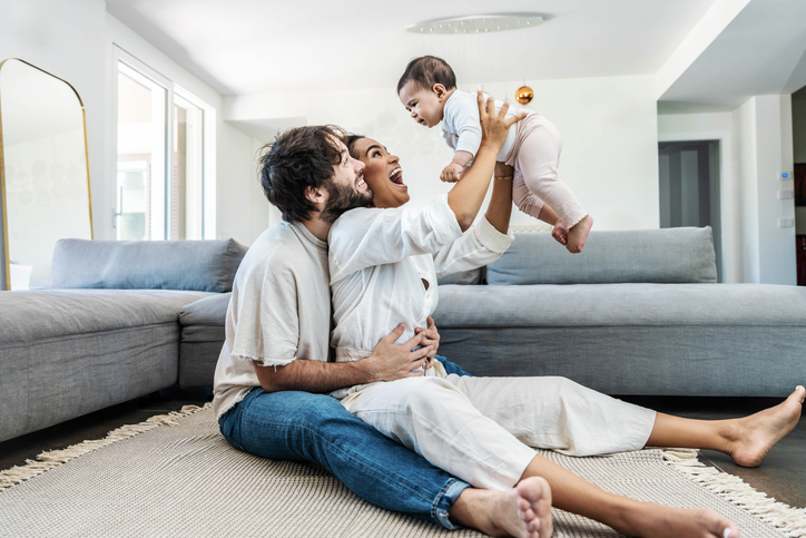 Wife and husband playing with their baby
